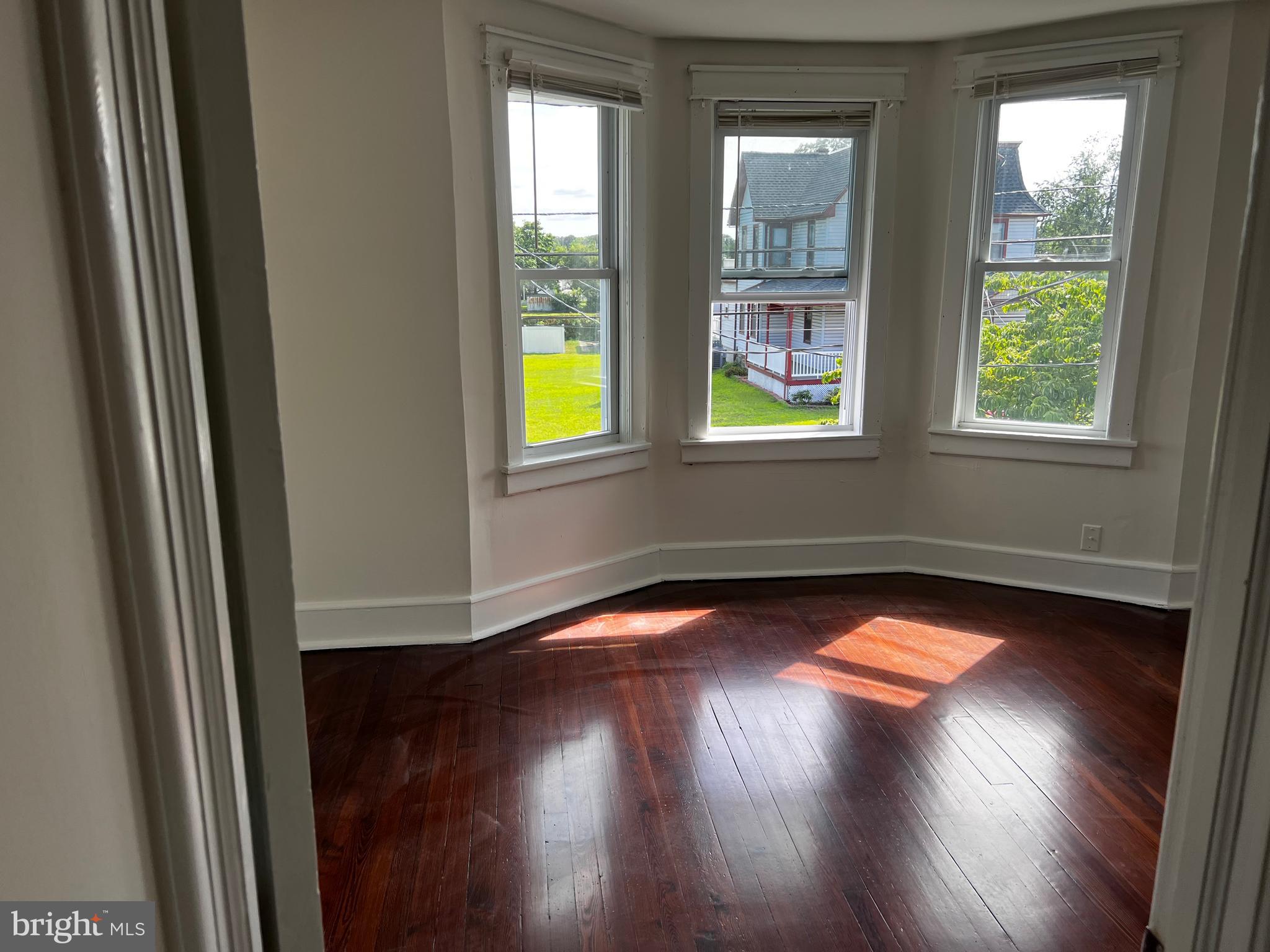 529 Bridgeboro Street Riverside, NJ 08075 - Photo 4 of 7 a view of empty room with window and wooden floor