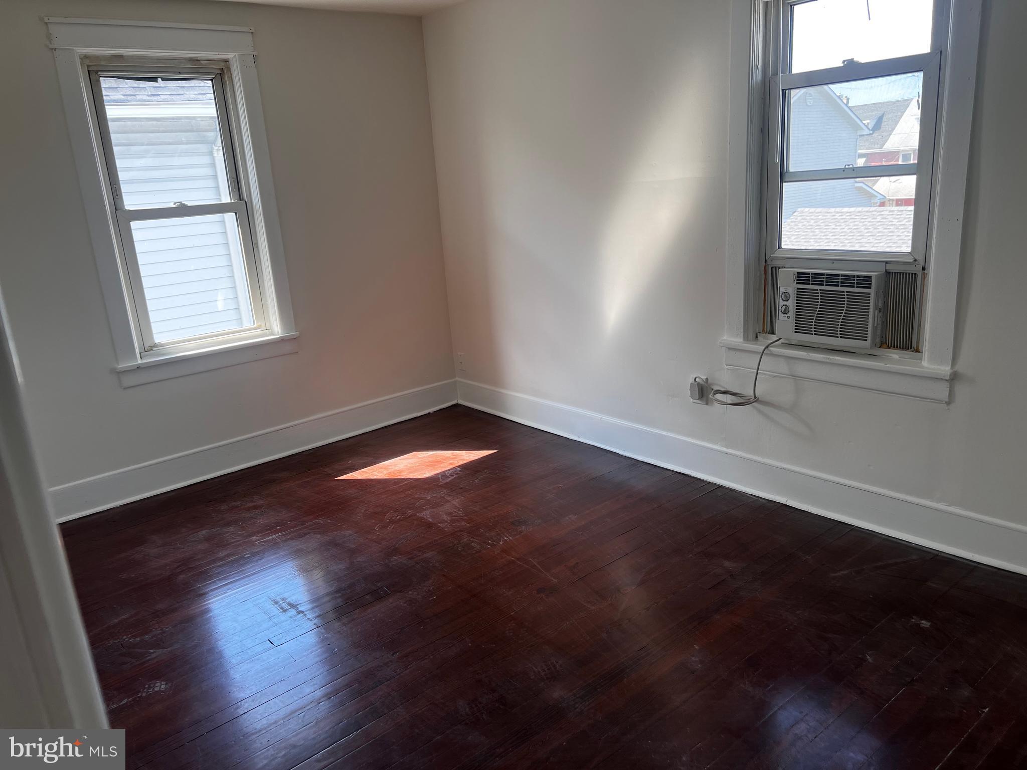 529 Bridgeboro Street Riverside, NJ 08075 - Photo 6 of 7 an empty room with wooden floor and windows