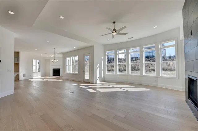 a large kitchen with stainless steel appliances granite countertop a sink a stove and a refrigerator