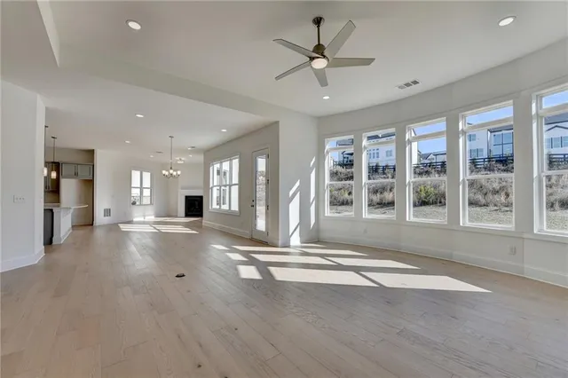 a view of an empty room with a window and fireplace