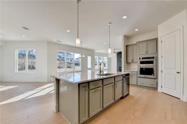 an empty room with a window and a ceiling fan