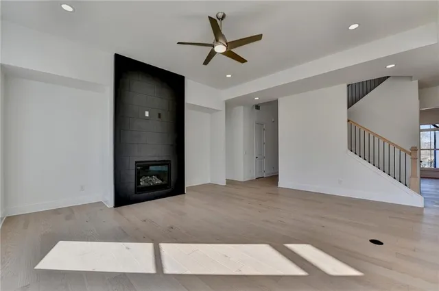 a living room with furniture ceiling fan and a window