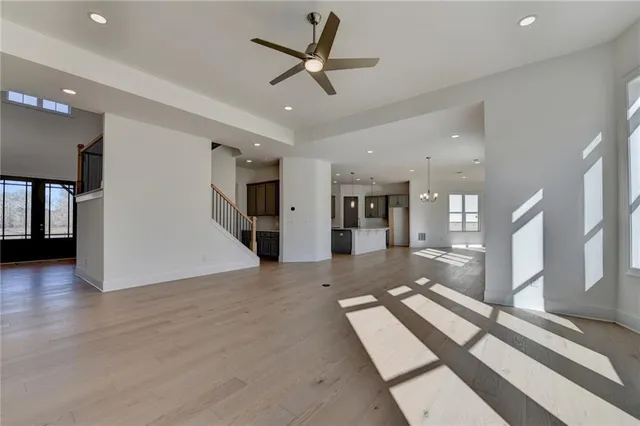 a bathroom with a bathtub shower sink mirror and toilet