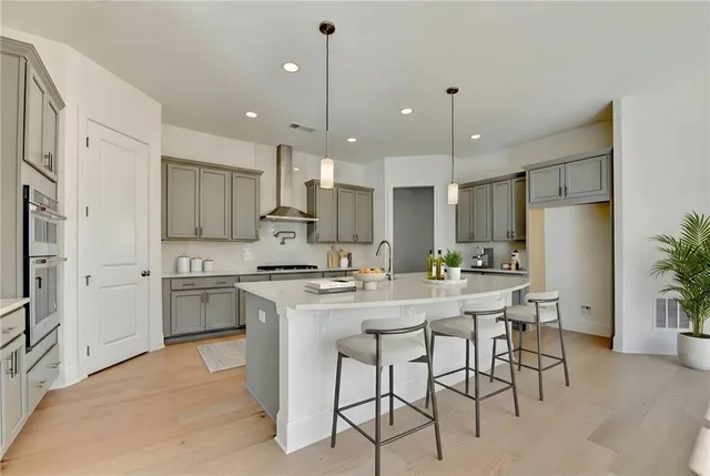 a view of a dining room with furniture a chandelier and wooden floor