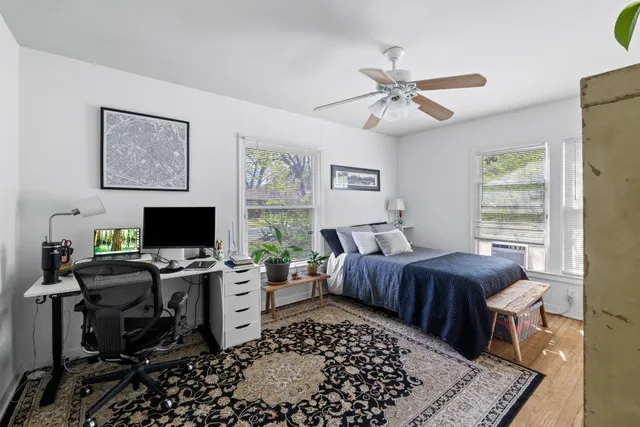 a bedroom with a bed furniture and a book shelf