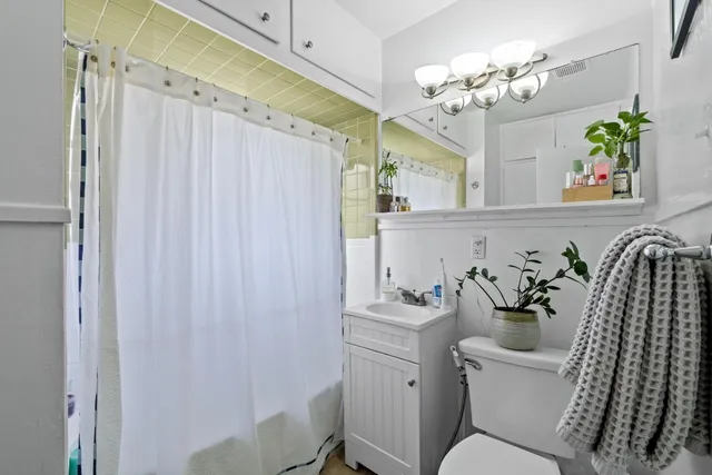 a view of a patio with table and chairs with wooden fence and plants