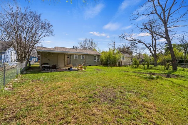 a view of a house with backyard and sitting area