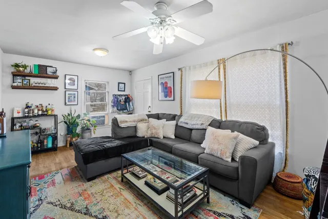 a living room with furniture and a chandelier
