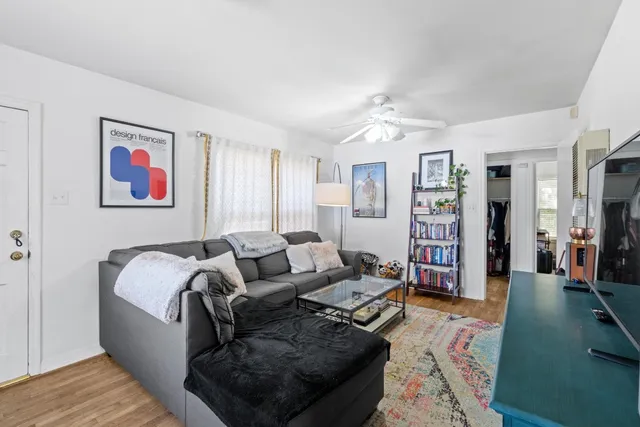 a living room with furniture and wooden floor