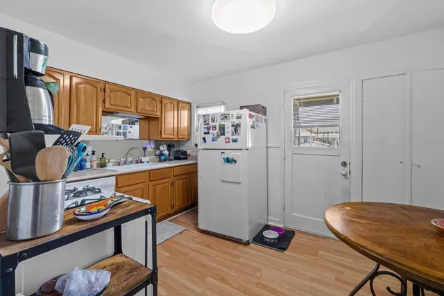 a kitchen with a refrigerator and a stove top oven