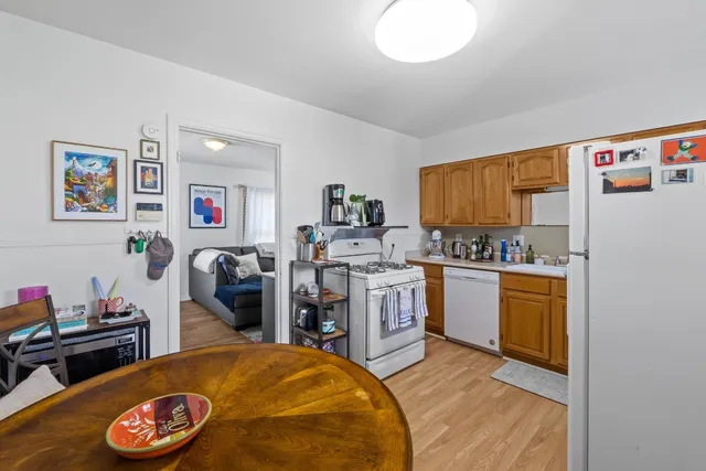 a kitchen with stainless steel appliances a stove a sink and a refrigerator