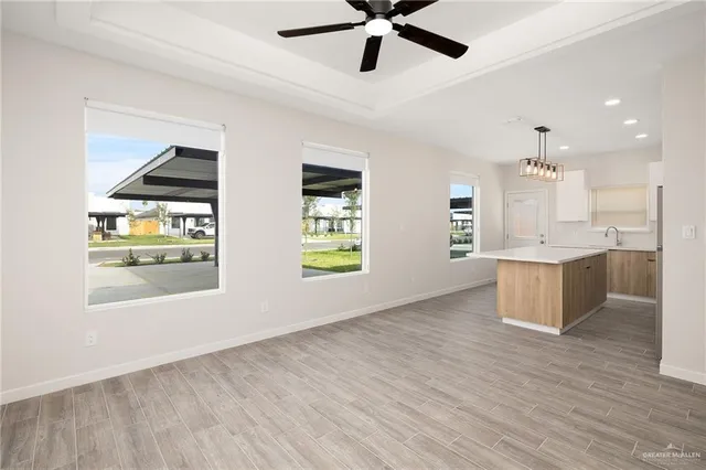 a kitchen with kitchen island white cabinets and stainless steel appliances