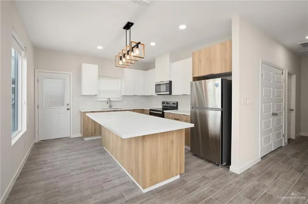 an empty room with cabinet and a ceiling fan