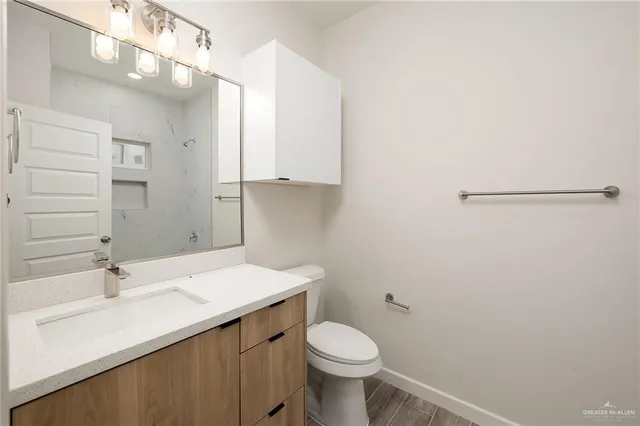 an empty room with a ceiling fan and hardwood floor
