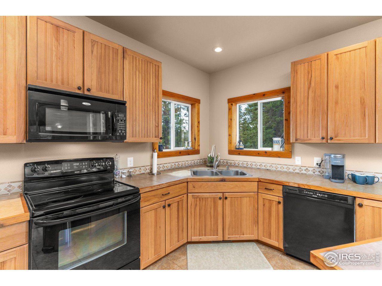 308 Pinon Circle Black Hawk, CO 80422 - Photo 10 of 37 a kitchen with a sink stove and microwave