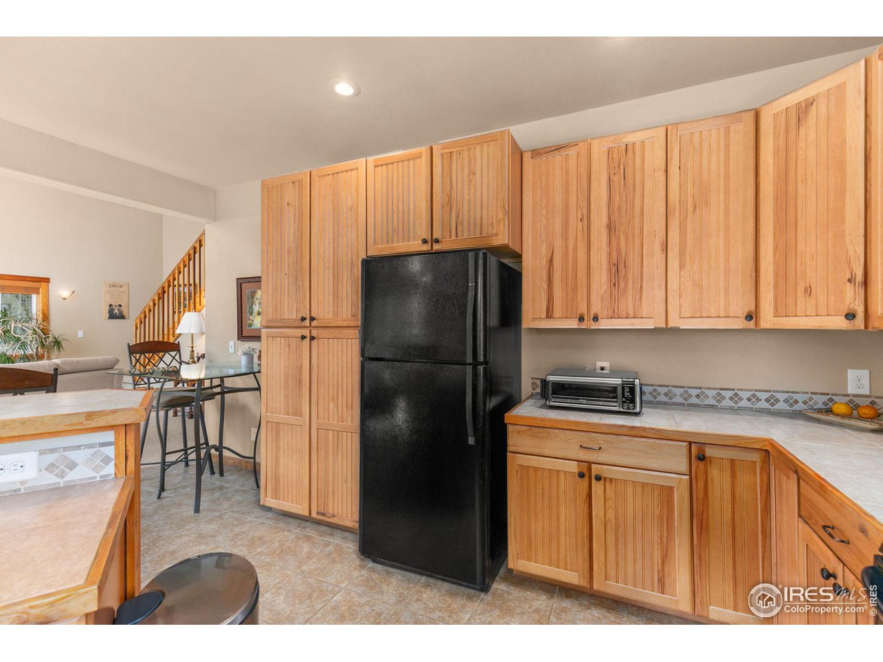 308 Pinon Circle Black Hawk, CO 80422 - Photo 11 of 37 a kitchen with stainless steel appliances granite countertop a refrigerator a sink a stove with wooden cabinets