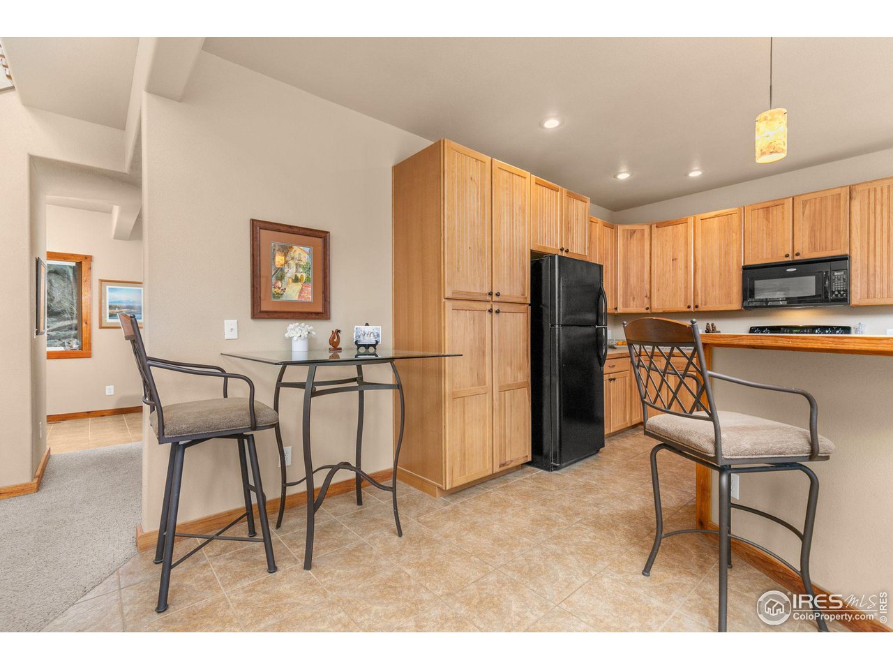 308 Pinon Circle Black Hawk, CO 80422 - Photo 12 of 37 a kitchen with stainless steel appliances kitchen island granite countertop a refrigerator and a dining table