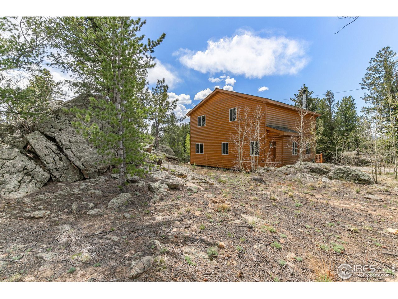 308 Pinon Circle Black Hawk, CO 80422 - Photo 24 of 37 a view of a blue house with a yard