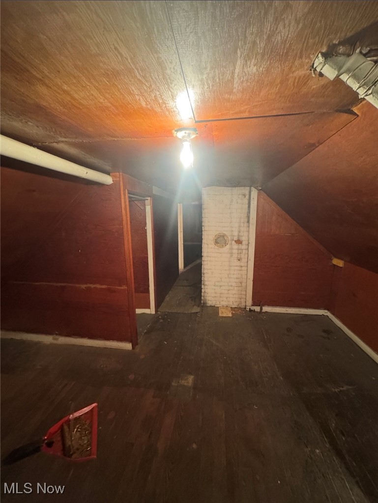 12406 Kinsman Road Cleveland, OH 44120 - Photo 23 of 29 Bonus room with lofted ceiling and dark wood-style flooring