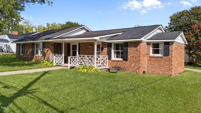 a front view of a house with a yard table and chairs