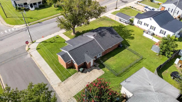 an aerial view of a house with a swimming pool