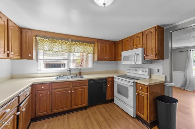a kitchen with a stove sink and cabinets