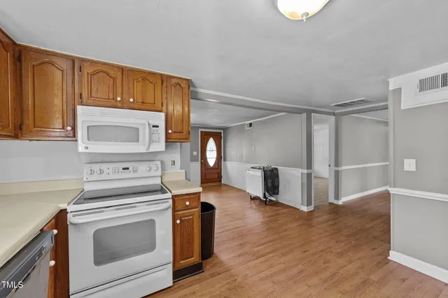 a kitchen that has a stove and a microwave oven