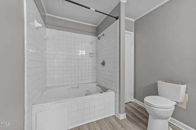 a bathroom with a toilet and shower