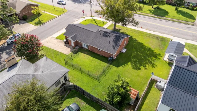an aerial view of a house with a swimming pool