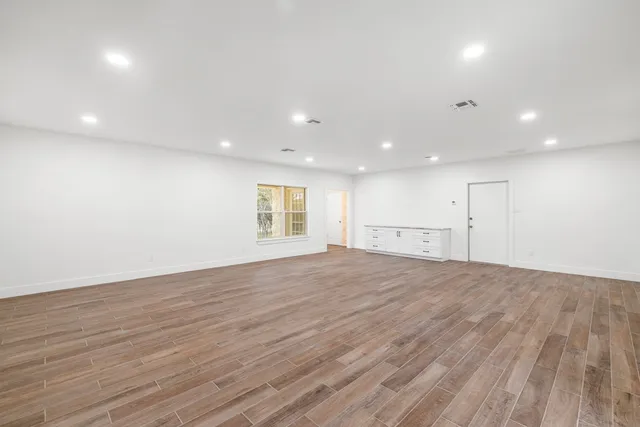 a living room with furniture fireplace and dining table with wooden floor