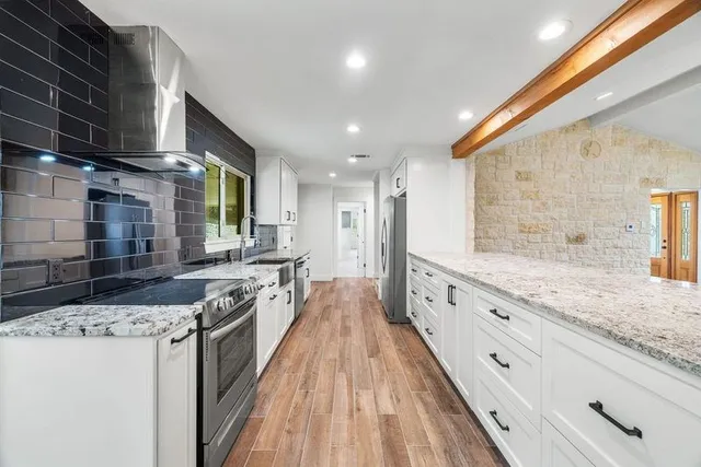 a spacious bedroom with a large bed and a flat screen tv