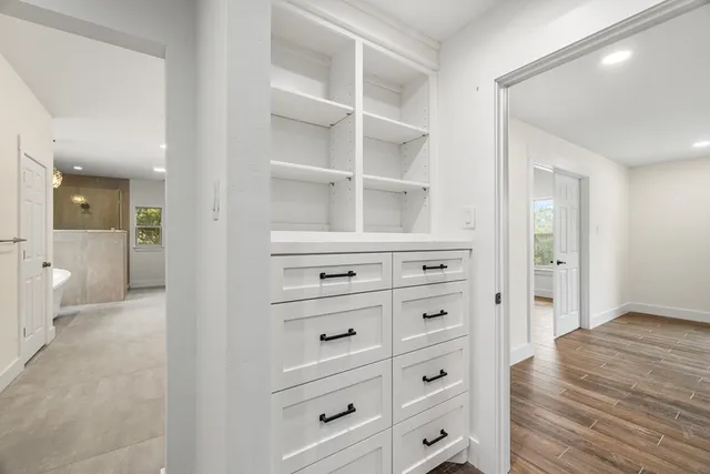 a spacious bathroom with a double vanity sink a toilet and a mirror
