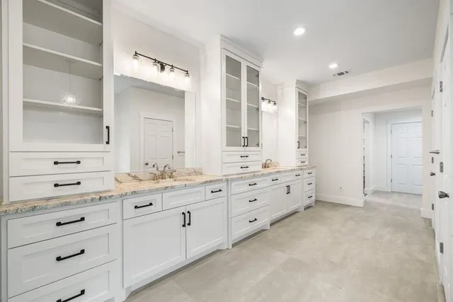 a view of a livingroom with a fireplace and a chandelier fan