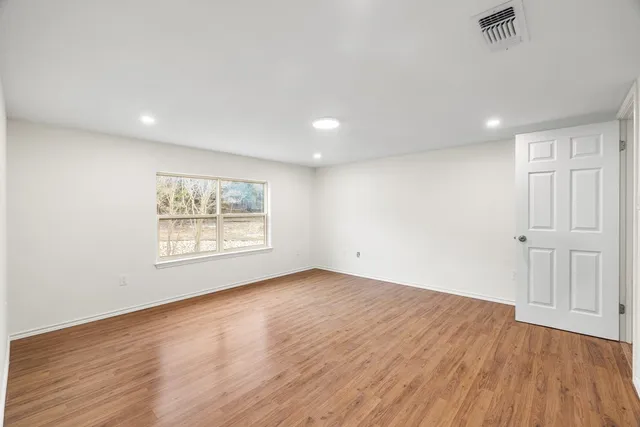 an aerial view of a house with a yard and lake view