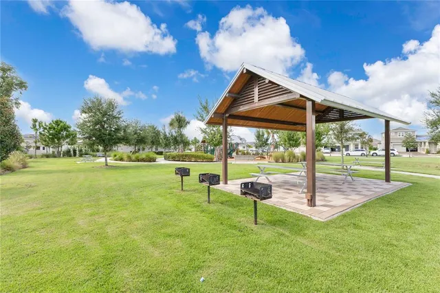 a backyard of a house with table and chairs