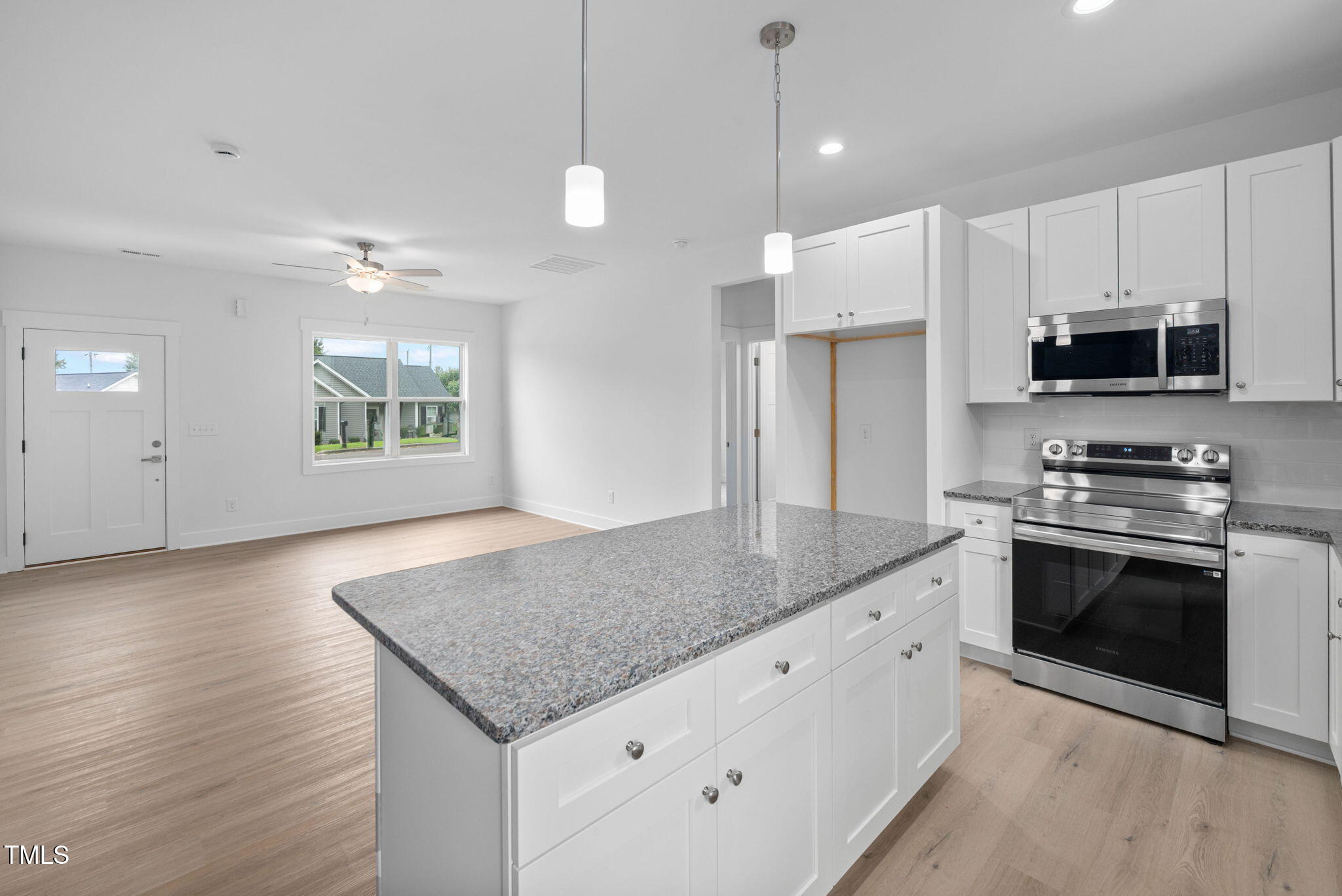 19 Southern Village Drive Roxboro, NC 27573 - Photo 10 of 31 a kitchen with stainless steel appliances granite countertop a stove a sink and a refrigerator