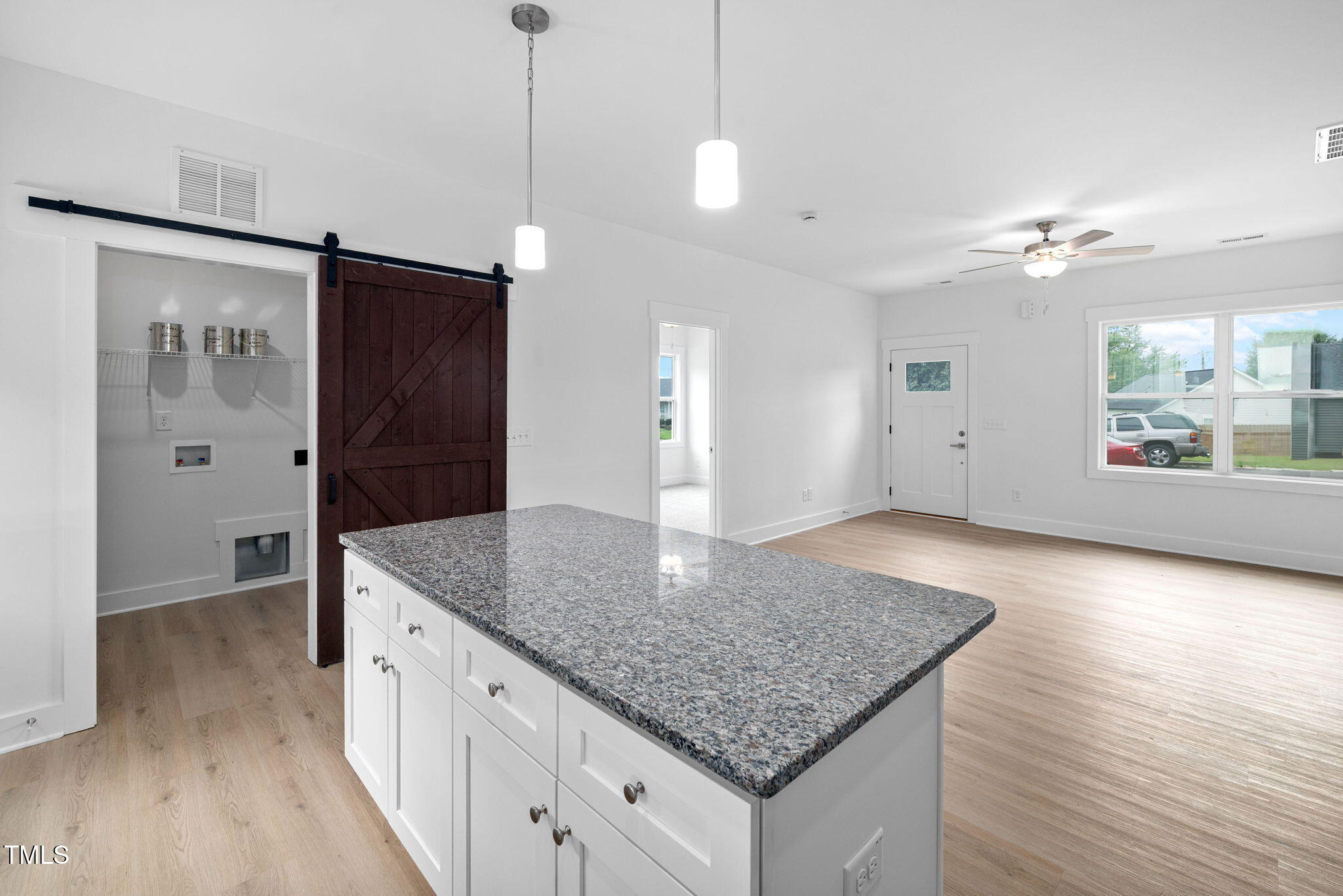 19 Southern Village Drive Roxboro, NC 27573 - Photo 11 of 31 a kitchen with kitchen island a counter space a sink and a refrigerator