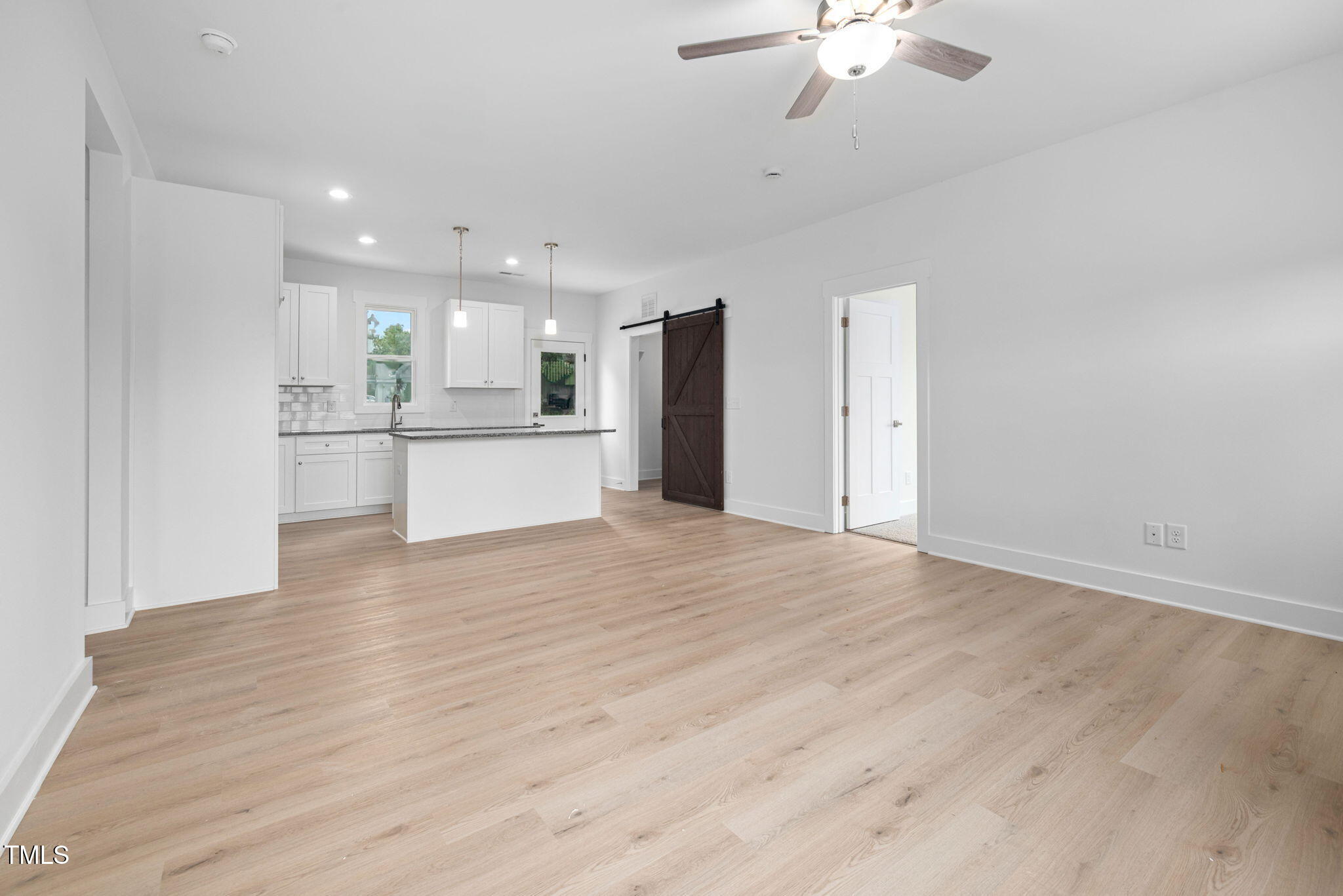 19 Southern Village Drive Roxboro, NC 27573 - Photo 13 of 31 a view of kitchen with refrigerator stove and wooden floor