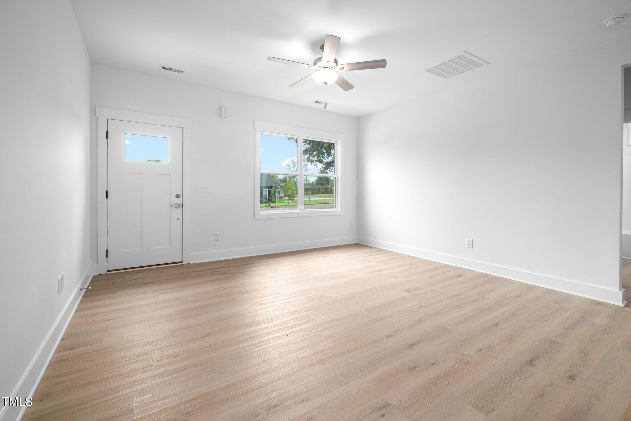 19 Southern Village Drive Roxboro, NC 27573 - Photo 6 of 31 an empty room with wooden floor chandelier fan and windows