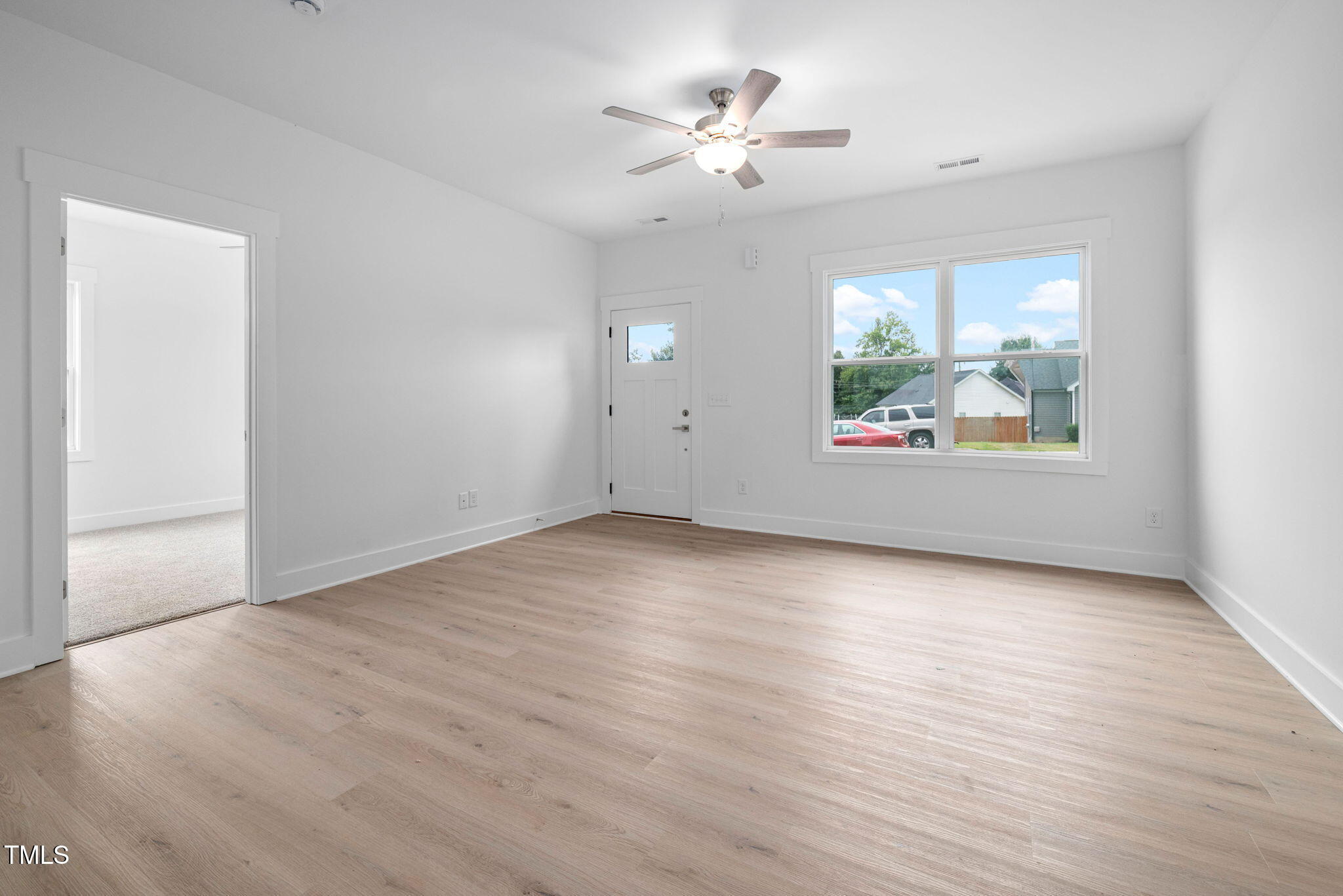 19 Southern Village Drive Roxboro, NC 27573 - Photo 7 of 31 an empty room with wooden floor and windows
