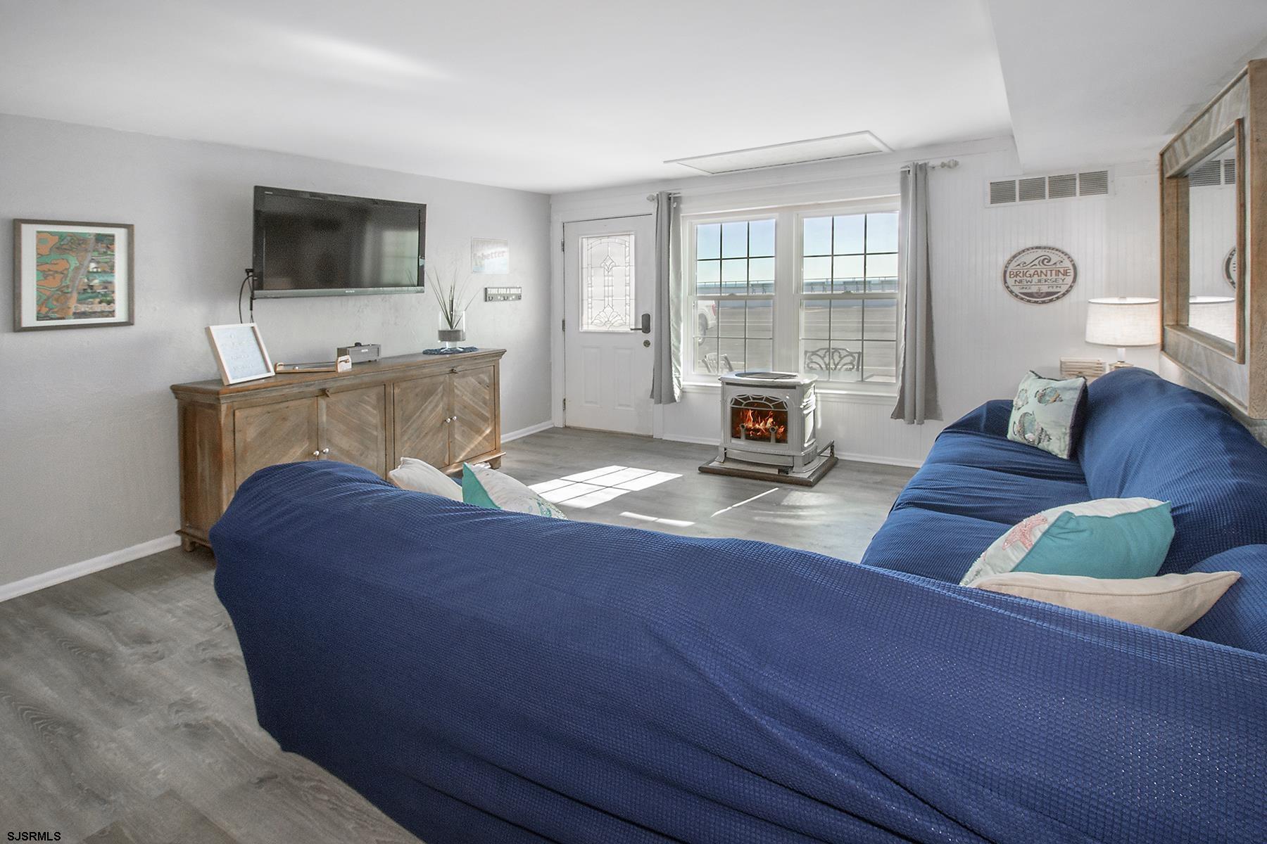 1101 East Brigantine Avenue, Unit 2 Brigantine, NJ 08203 - Photo 3 of 13 a living room with furniture and a flat screen tv