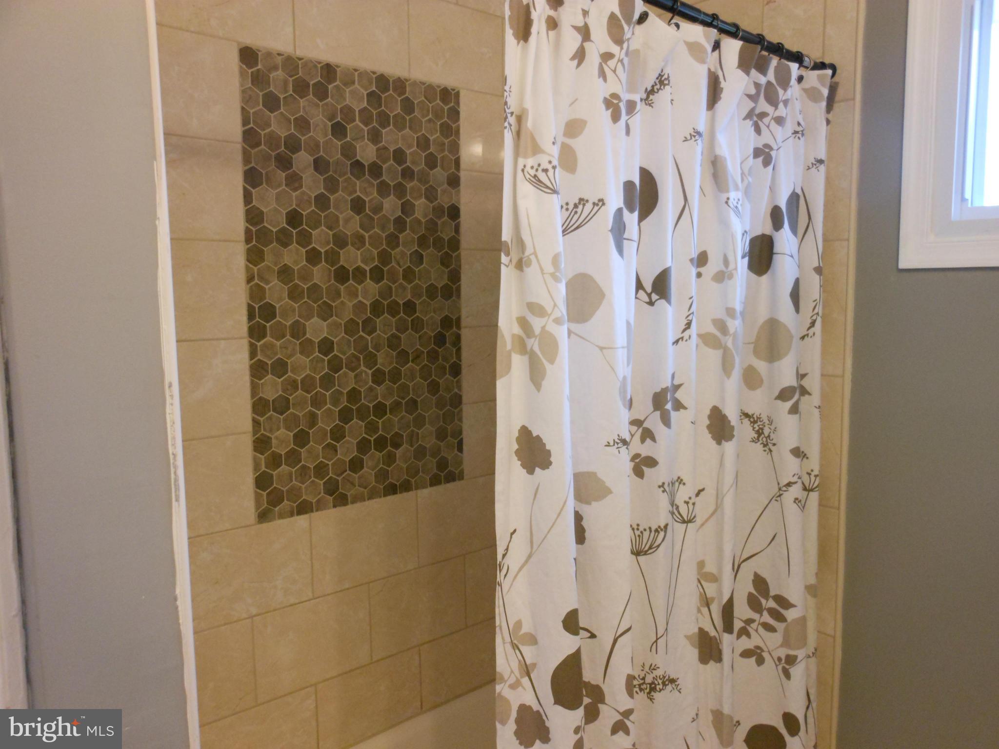 7302 Dooman Road Baltimore, MD 21244 - Photo 12 of 29 a bathroom with a shower curtain