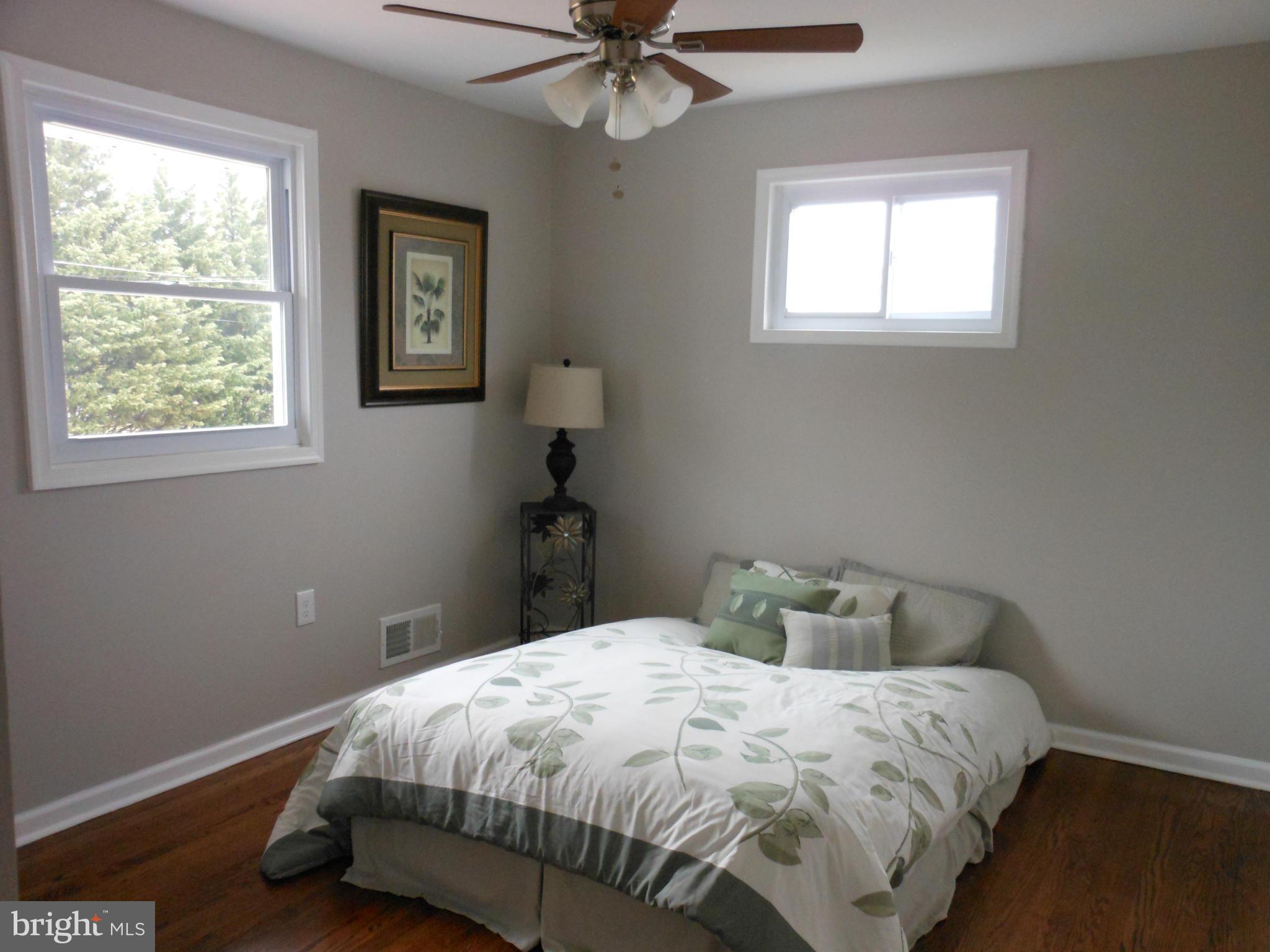 7302 Dooman Road Baltimore, MD 21244 - Photo 15 of 29 a bedroom with a bed and window