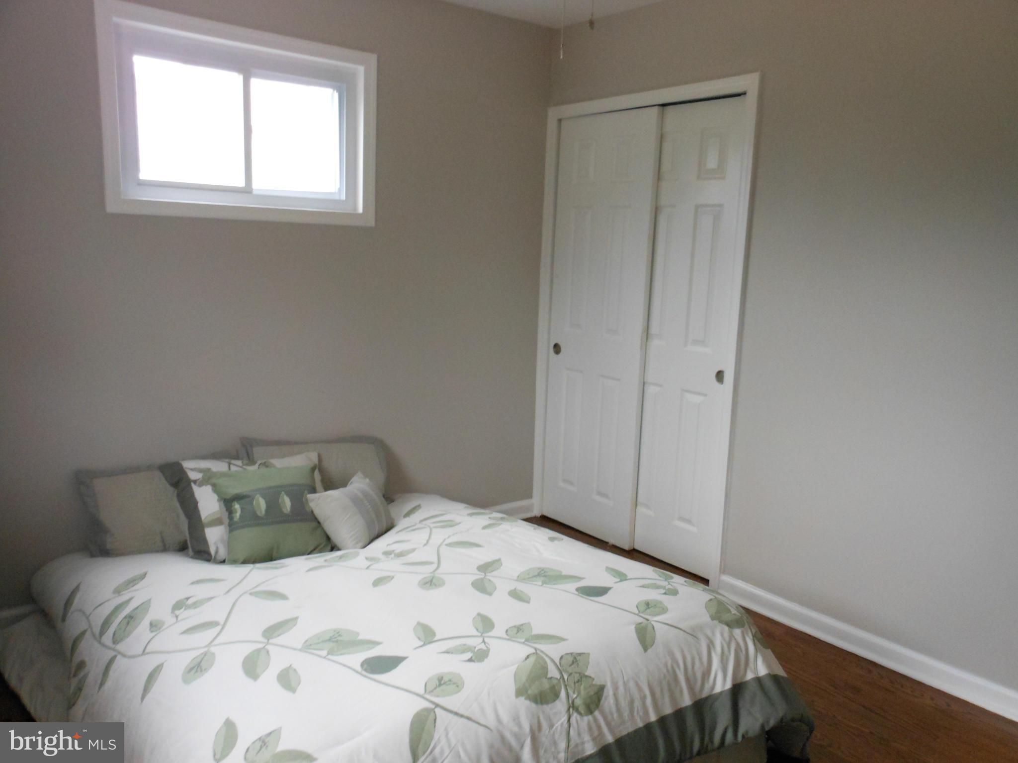 7302 Dooman Road Baltimore, MD 21244 - Photo 16 of 29 a bedroom with a bed and a window