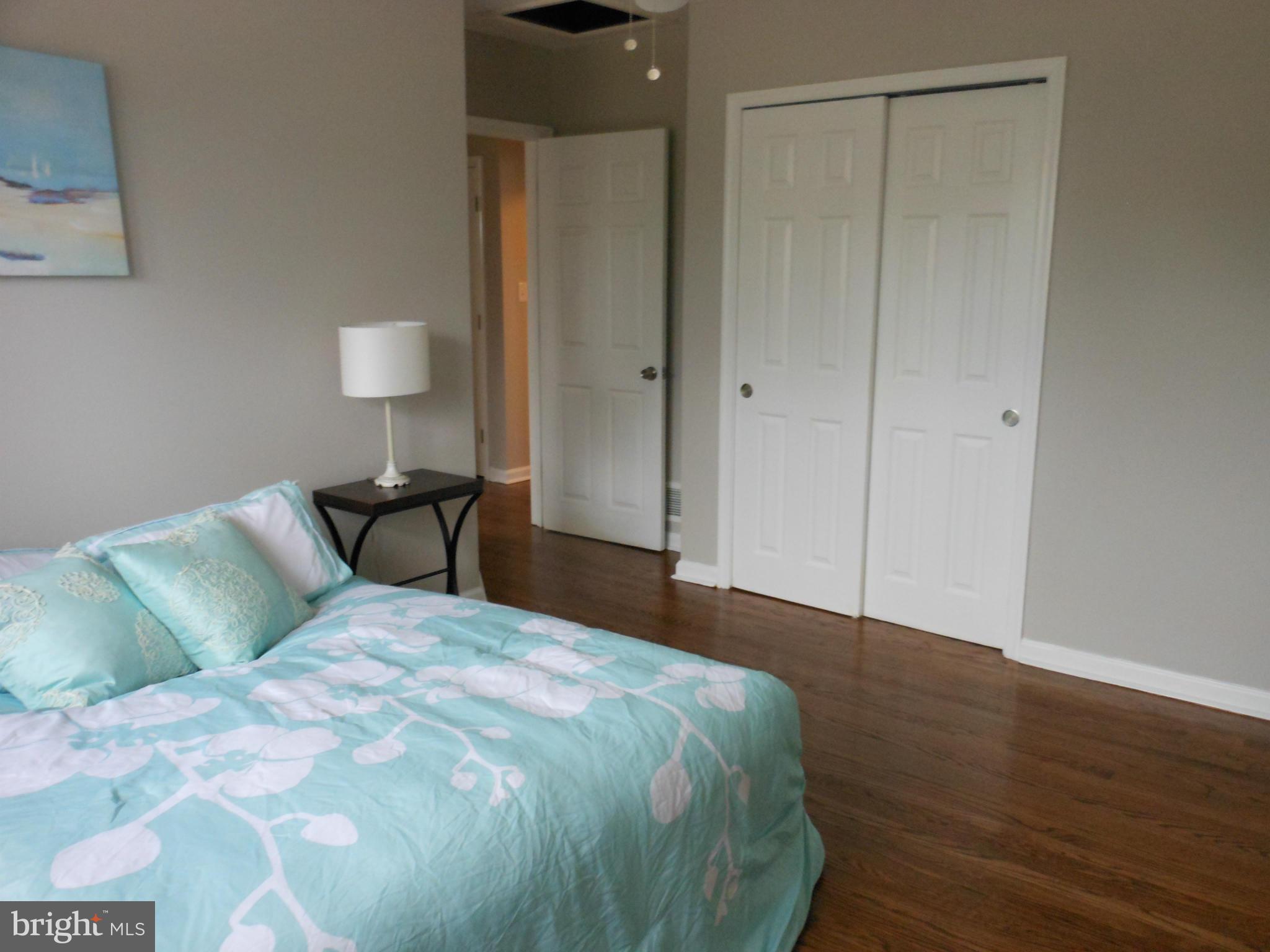 7302 Dooman Road Baltimore, MD 21244 - Photo 18 of 29 a bedroom with a bed and a painting on the wall