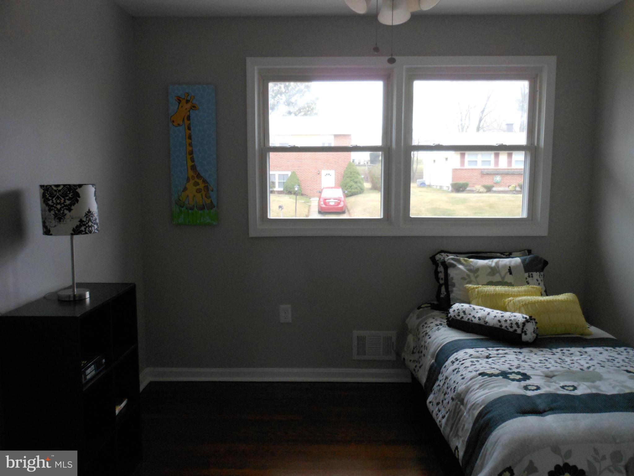 7302 Dooman Road Baltimore, MD 21244 - Photo 19 of 29 a bedroom with a bed and window