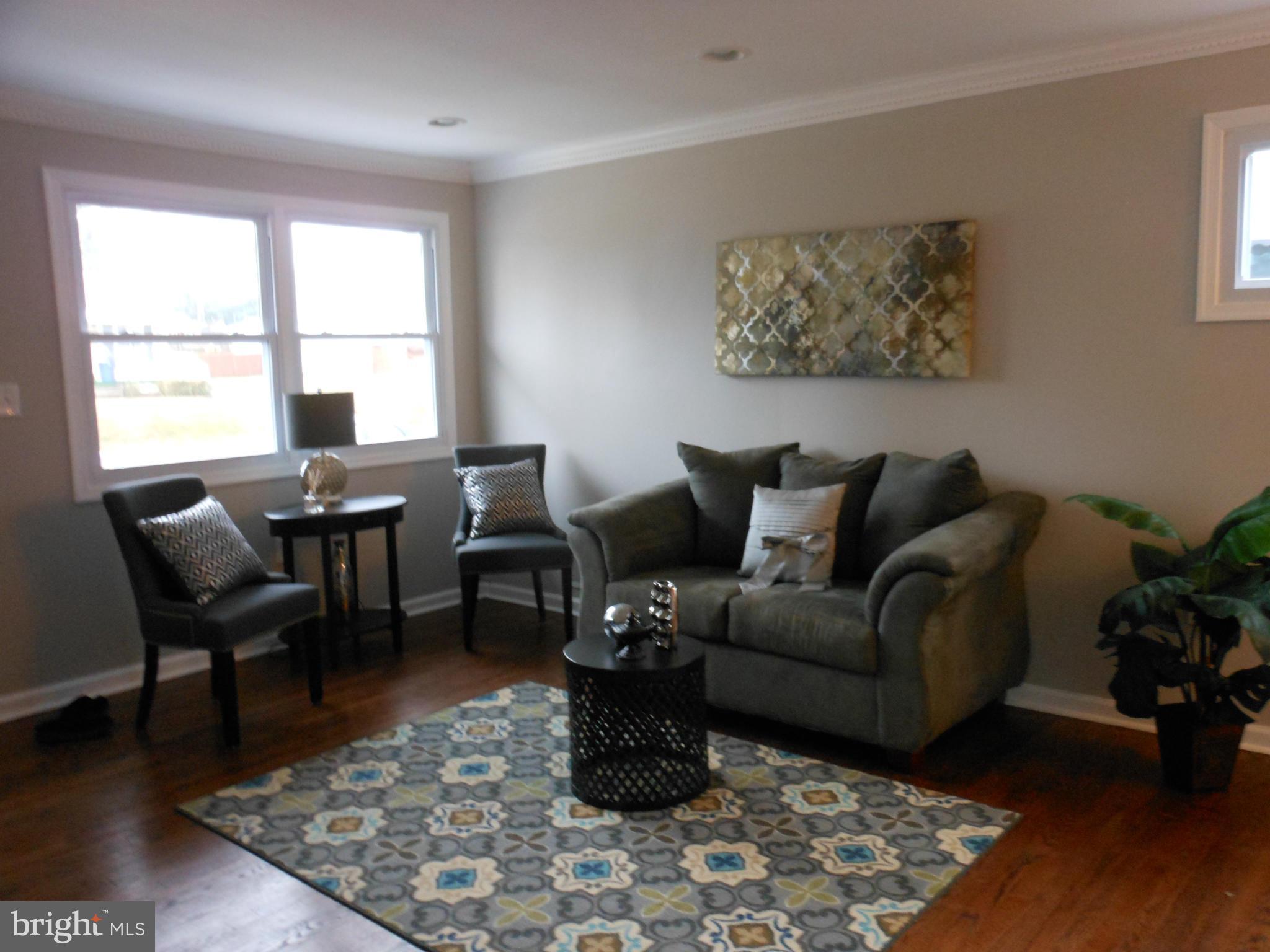 7302 Dooman Road Baltimore, MD 21244 - Photo 3 of 29 a living room with furniture wooden floor and a window