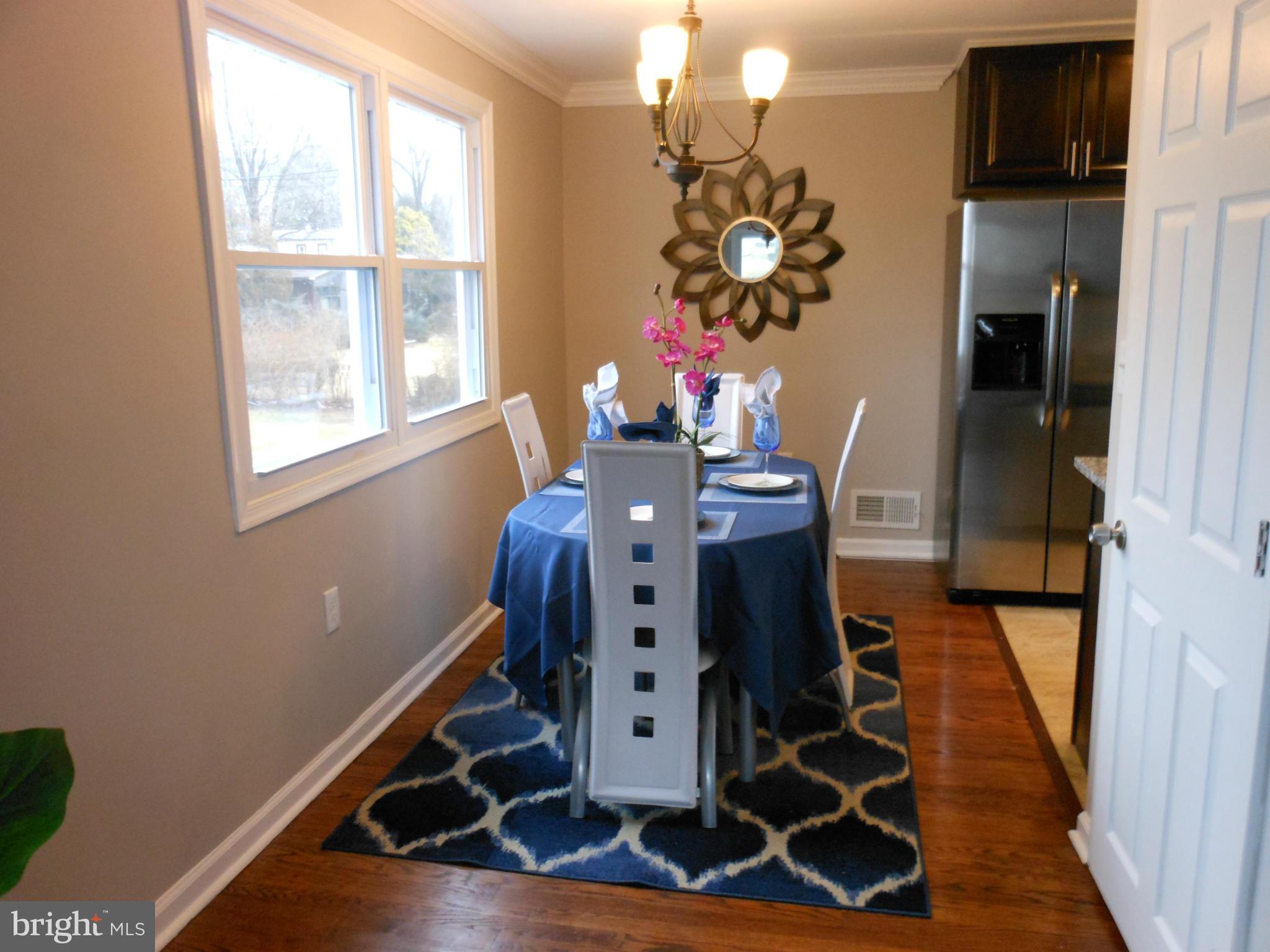 7302 Dooman Road Baltimore, MD 21244 - Photo 5 of 29 a view of a dining room with wooden floor