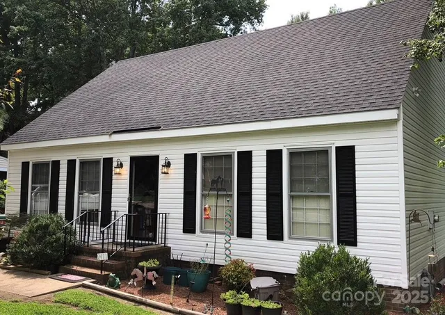 a backyard of a house with yard and outdoor seating