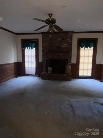 a view of empty room with a fireplace